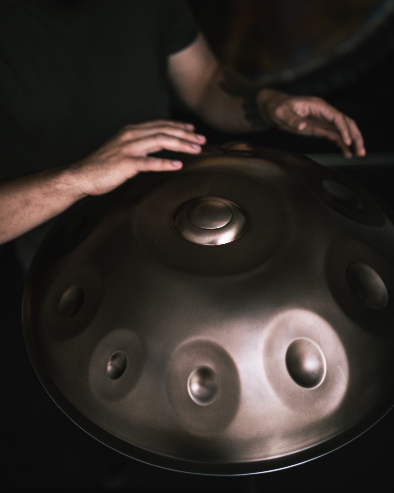 Hands playing a C Aegean handpan